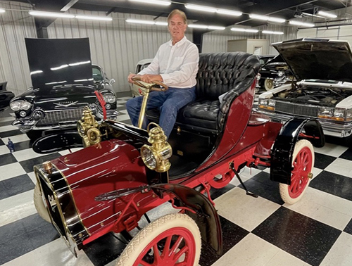 Dr Steven Greenberg seated in the historic 1903 Cadillac