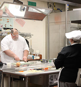 Teacher giving culinary lesson