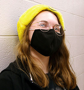 Student smiling and wearing yellow hat